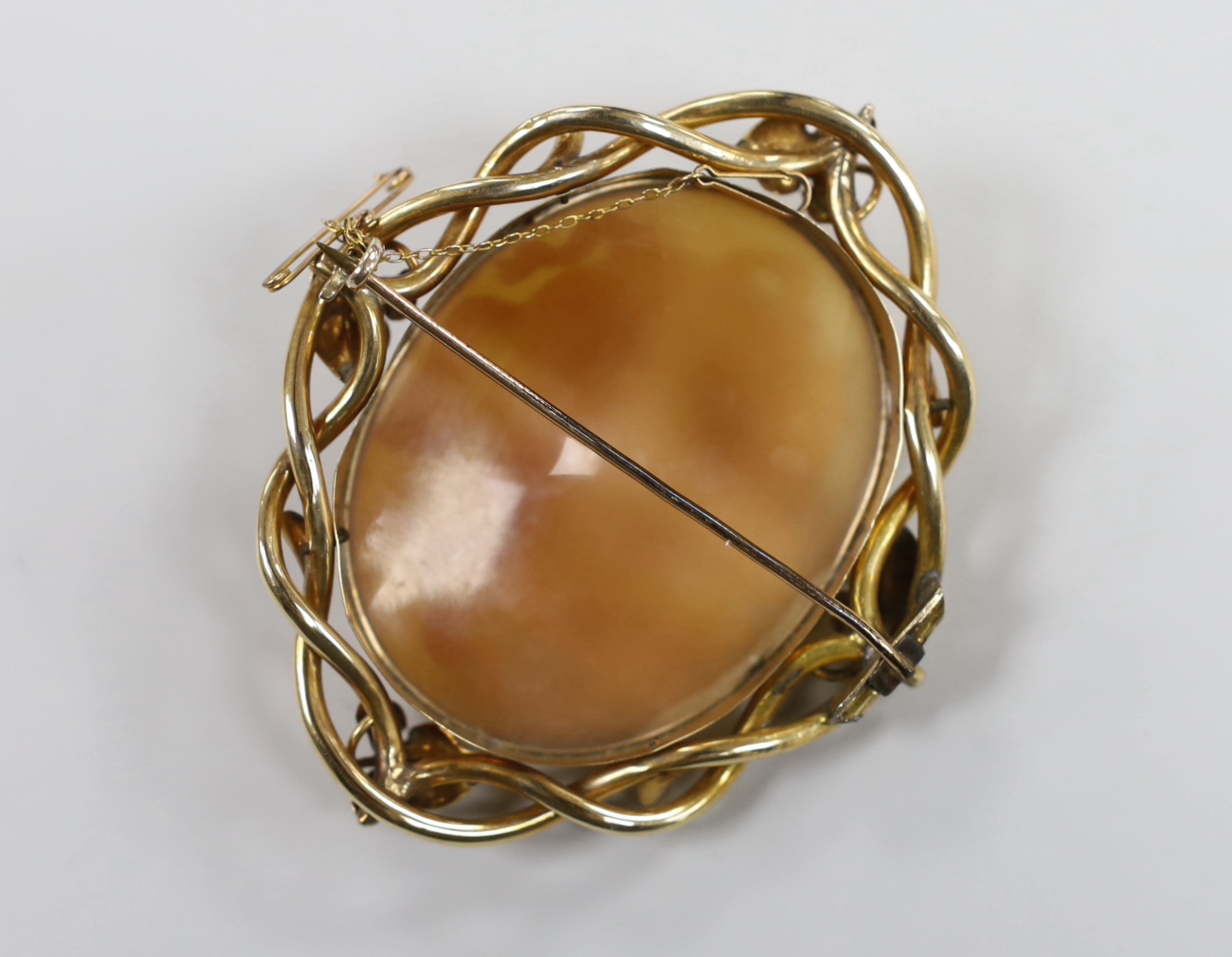 A Victorian yellow metal mounted oval cameo shell brooch, carved with the head of Medusa, 78mm.